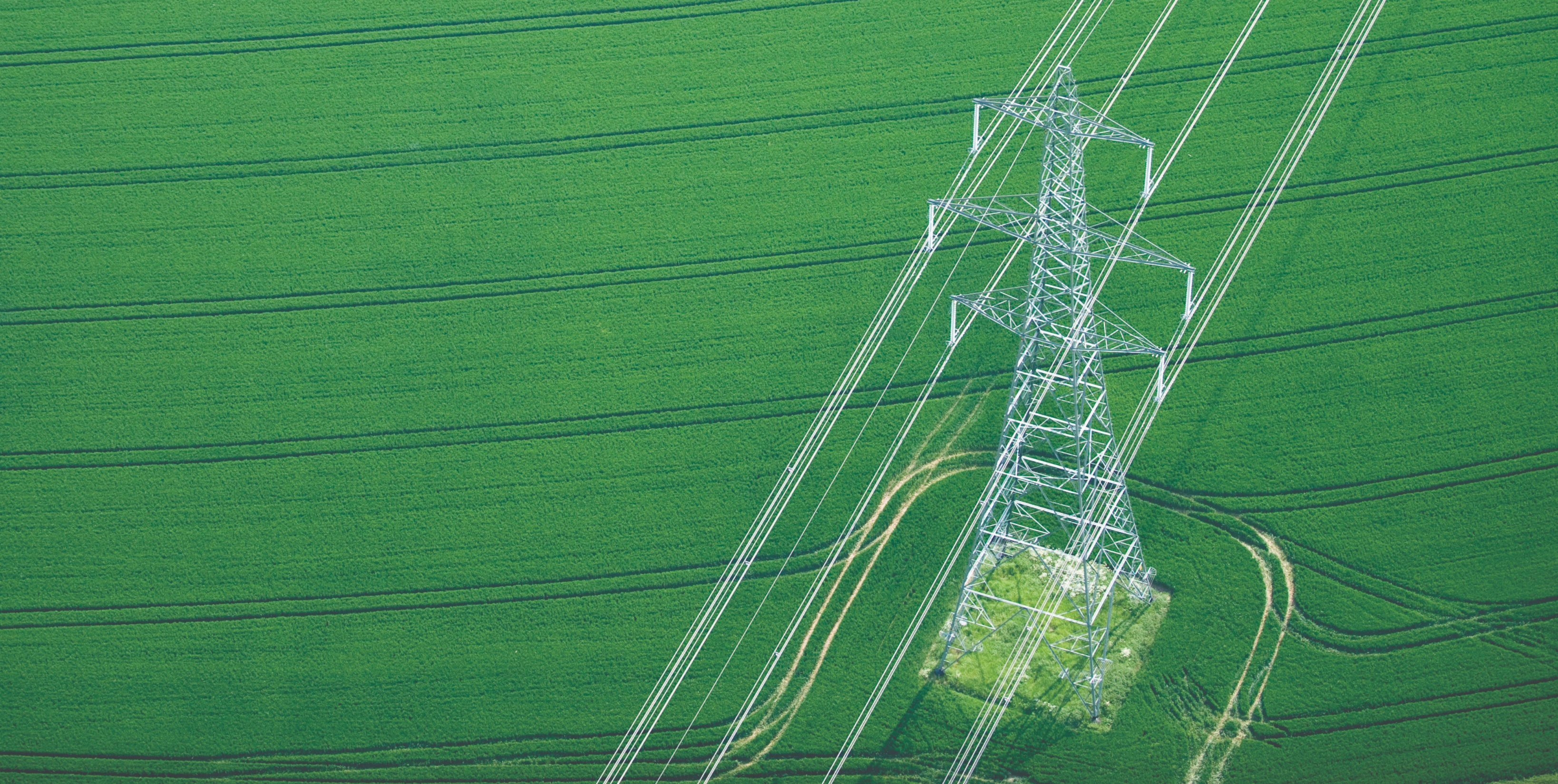 Aerial view of modern electrical grid infrastructure in a green field